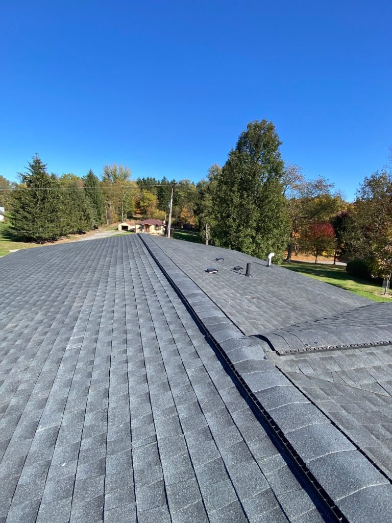 Skilled roofing contractor in Oakmont, PA performing a roof inspection