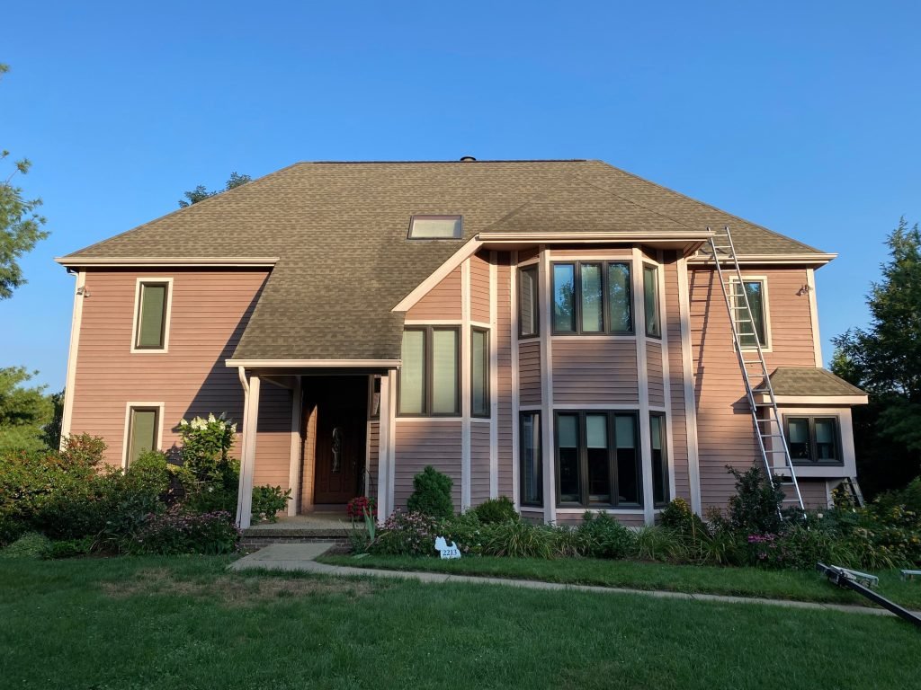 Reliable roofing contractor near me in Butler, PA inspecting residential roof damage